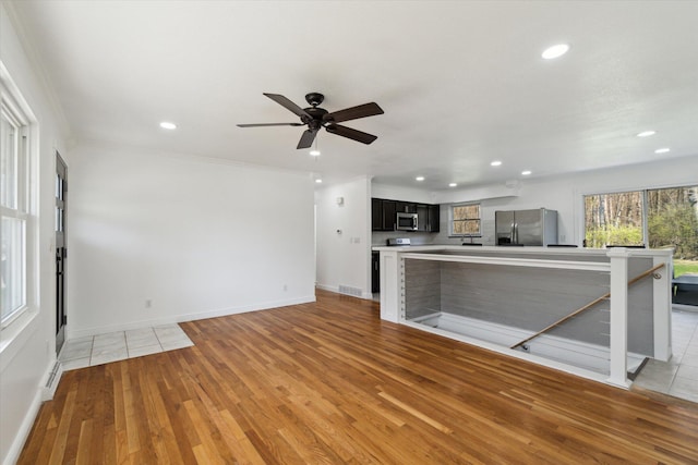 unfurnished living room with recessed lighting and light wood finished floors
