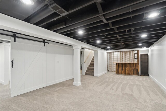 finished basement with baseboards, visible vents, stairs, and carpet flooring