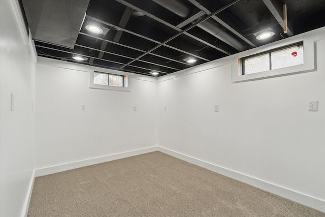 below grade area featuring baseboards and carpet