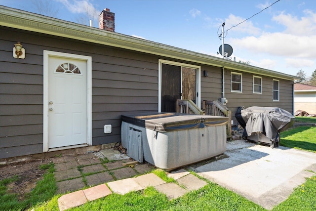 back of house with a patio and a chimney