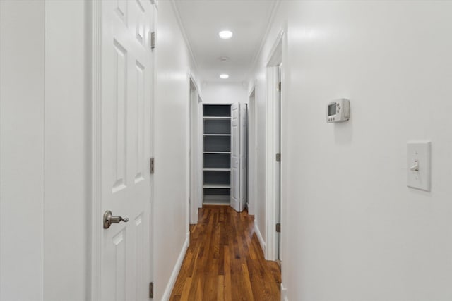 hall featuring baseboards, recessed lighting, and dark wood-type flooring