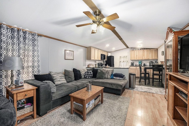 living area featuring ornamental molding, a ceiling fan, light wood finished floors, and vaulted ceiling