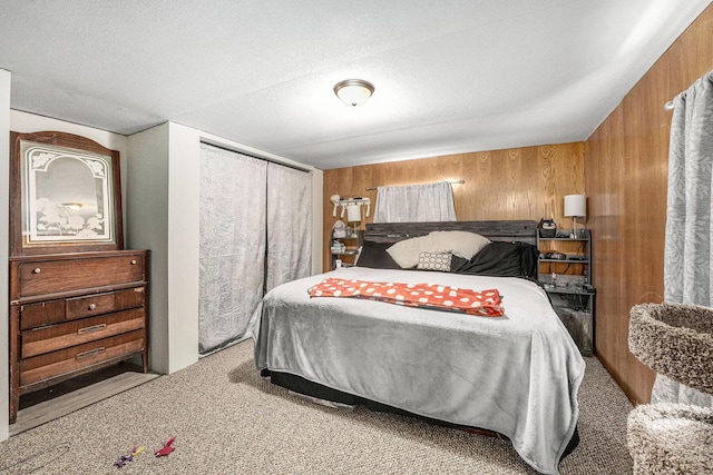 carpeted bedroom featuring wooden walls