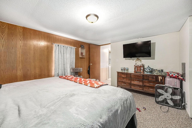 bedroom with a textured ceiling and carpet flooring