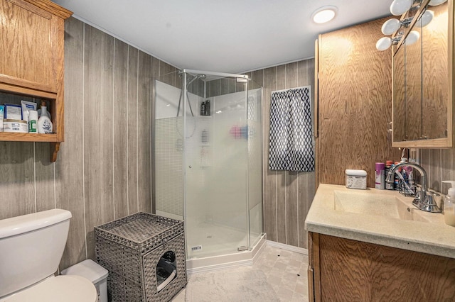 bathroom with toilet, a stall shower, and wood walls