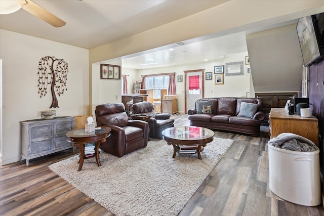 living room with ceiling fan and dark wood-style floors