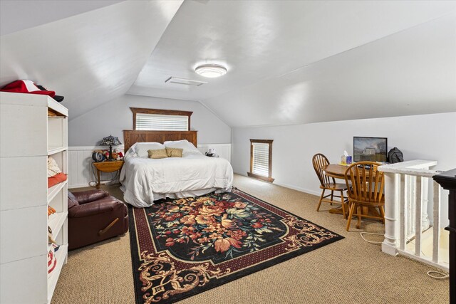 carpeted bedroom featuring multiple windows and lofted ceiling