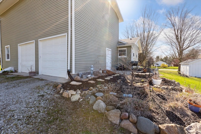 view of side of property with a garage and driveway