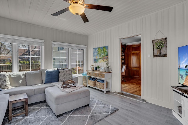 living area with ceiling fan and wood finished floors