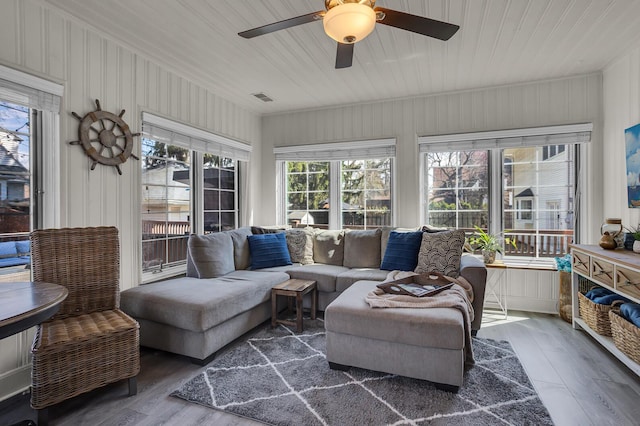 sunroom / solarium with visible vents and wood finished floors