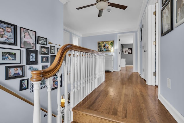 corridor featuring stairway, hardwood / wood-style floors, crown molding, and baseboards