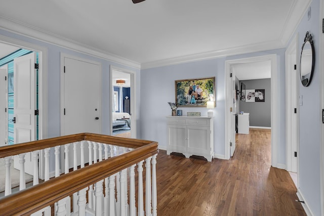 hallway with baseboards, wood finished floors, a wealth of natural light, and crown molding