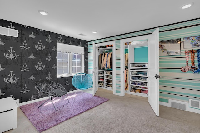 bedroom featuring visible vents, wallpapered walls, and carpet
