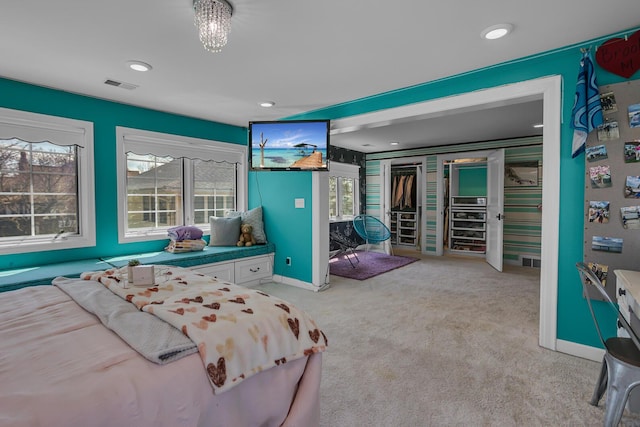 carpeted bedroom featuring baseboards, visible vents, multiple windows, and recessed lighting