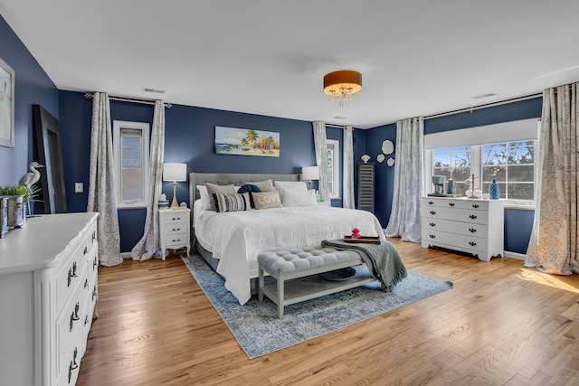 bedroom featuring visible vents and light wood-style floors