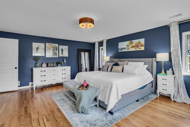 bedroom featuring visible vents and wood finished floors