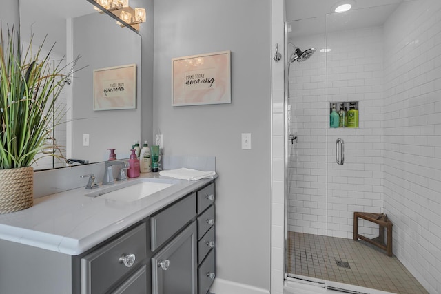 full bath with vanity and a shower stall