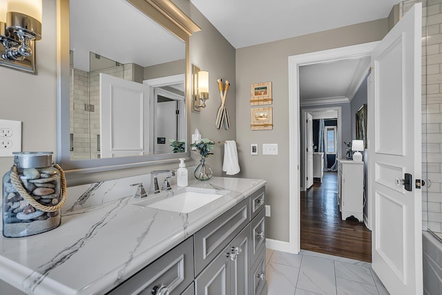 bathroom featuring a shower with shower door, vanity, marble finish floor, and baseboards