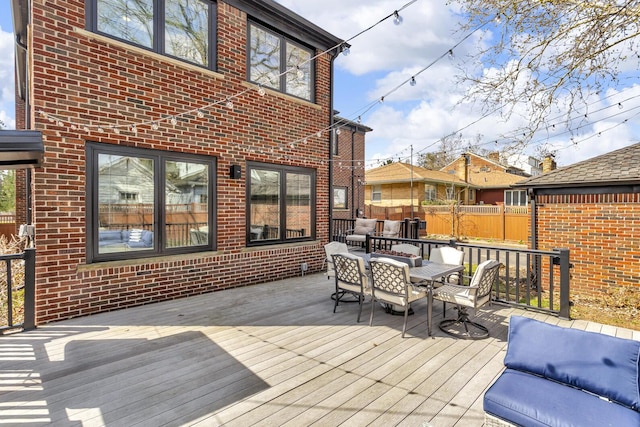 wooden deck featuring fence and outdoor dining space
