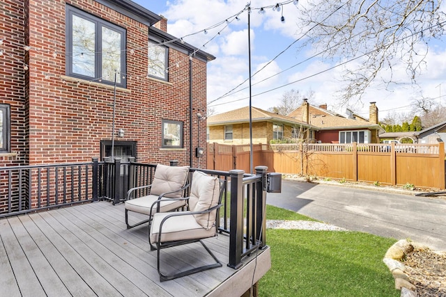 wooden terrace featuring fence