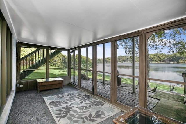 unfurnished sunroom with a water view