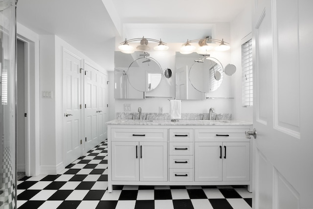 bathroom with double vanity, a sink, and tile patterned floors