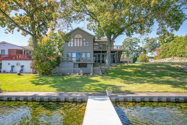 back of property with a yard, stairs, and a wooden deck