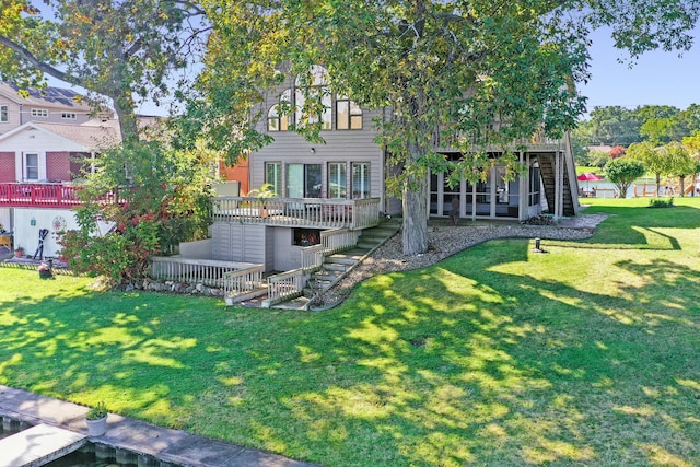 back of house with a lawn, a wooden deck, and stairway