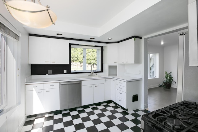 kitchen featuring black range with gas cooktop, light countertops, dishwasher, and dark floors