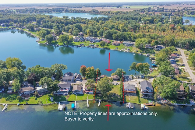 birds eye view of property featuring a water view and a residential view