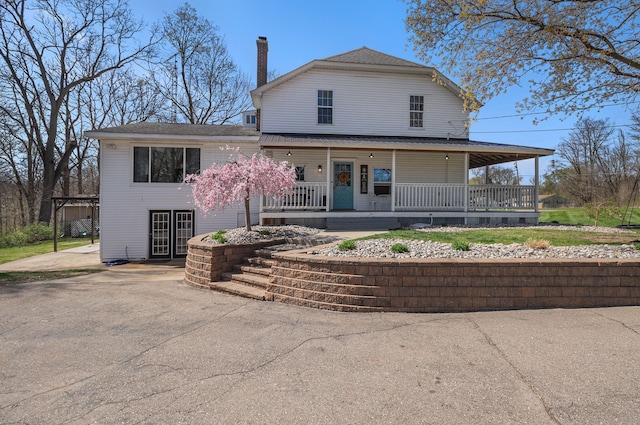 view of front of house with a porch and a chimney