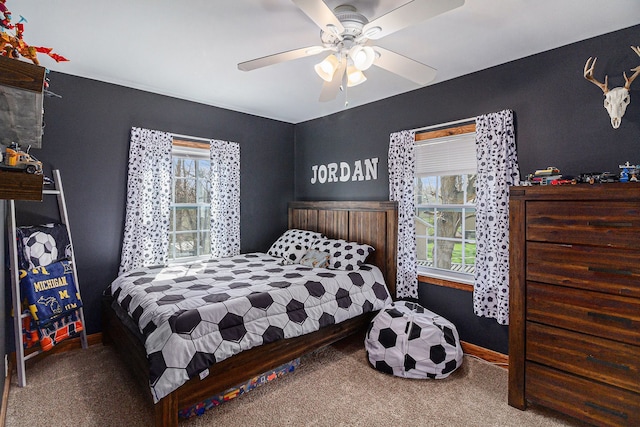 carpeted bedroom featuring a ceiling fan and baseboards