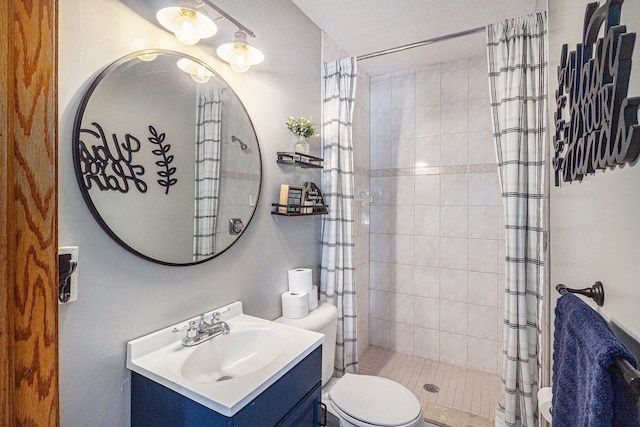 full bathroom featuring toilet, vanity, and a shower stall