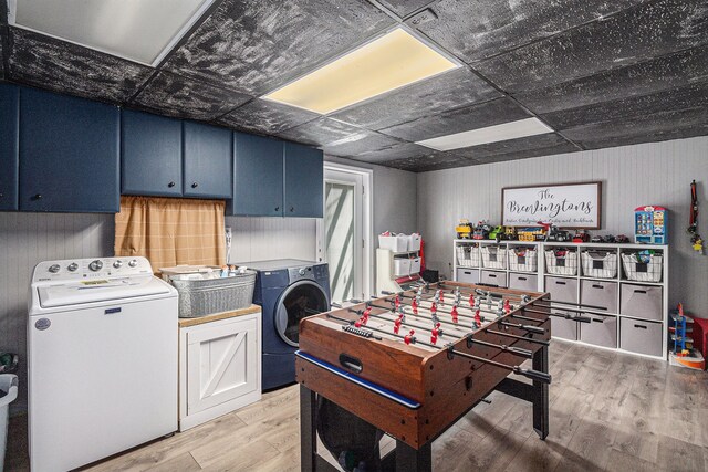 recreation room with light wood finished floors and washing machine and dryer