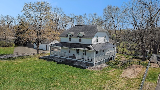 back of house featuring metal roof, a yard, and covered porch