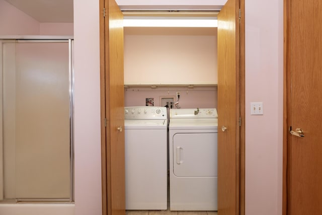 clothes washing area featuring washer and clothes dryer and laundry area