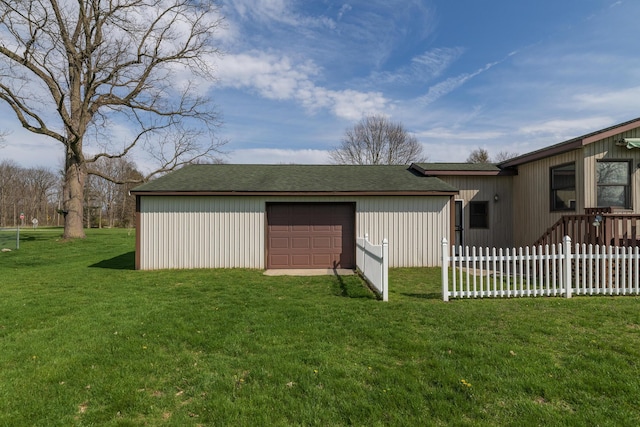 view of outbuilding with an outdoor structure, driveway, and fence