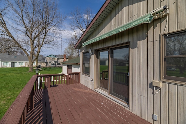 wooden deck with a residential view and a yard