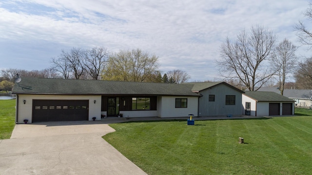 single story home with concrete driveway, a front yard, and an attached garage