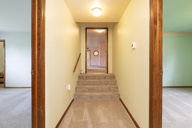 stairway with carpet flooring and baseboards