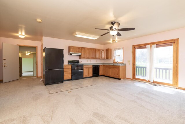 kitchen featuring a sink, under cabinet range hood, black appliances, a ceiling fan, and light colored carpet