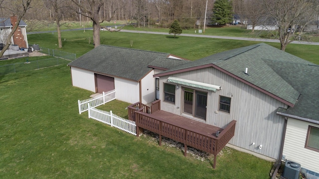 rear view of house with a wooden deck, a shingled roof, cooling unit, and a fenced backyard