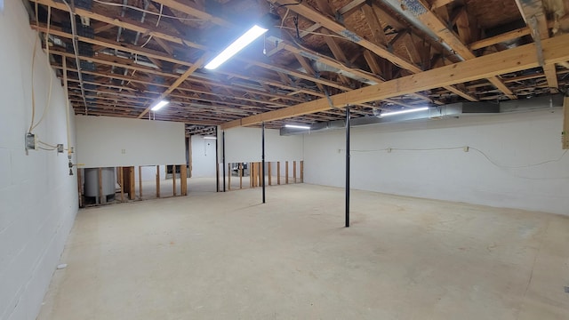 unfinished below grade area featuring concrete block wall