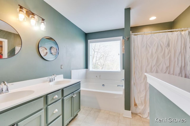 bathroom featuring double vanity, tile patterned flooring, a sink, and a bath