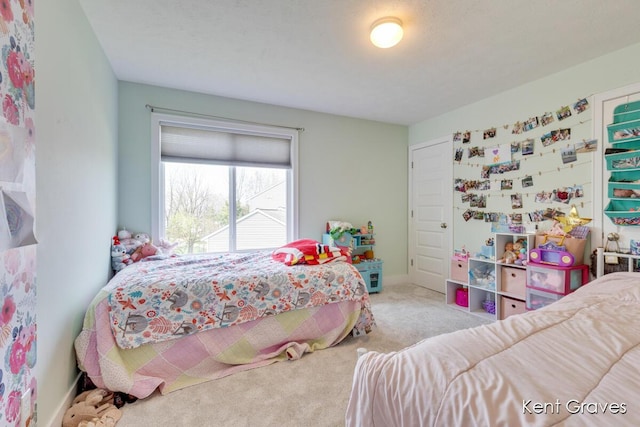 bedroom with carpet floors and baseboards
