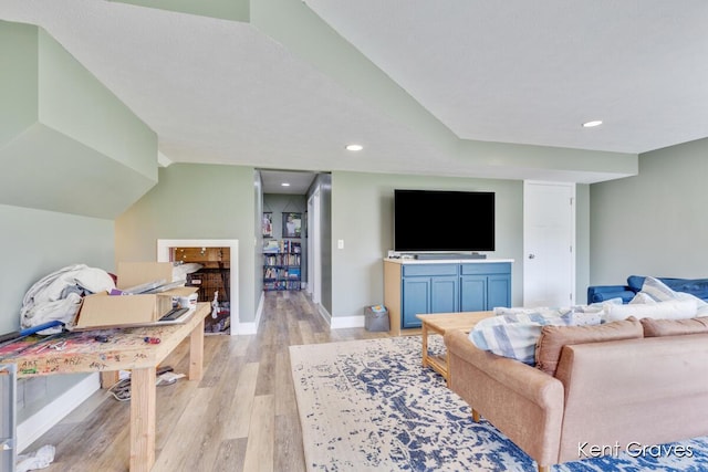 living room featuring baseboards, recessed lighting, and light wood-style flooring