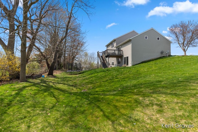 view of yard featuring a wooden deck and stairway
