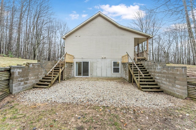 back of house with stairs