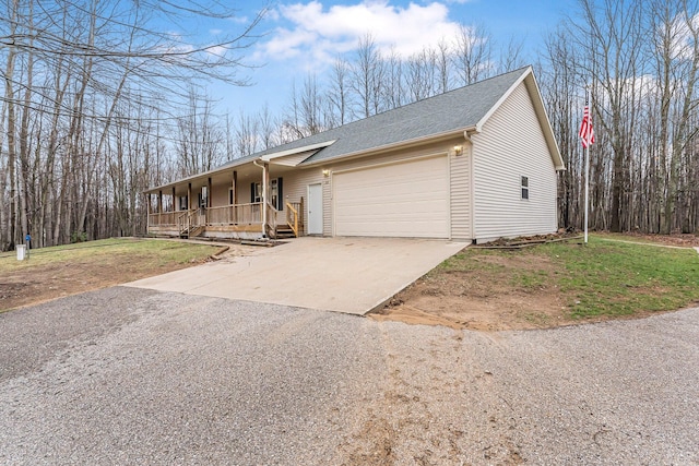single story home featuring a porch, a front yard, a garage, a shingled roof, and driveway