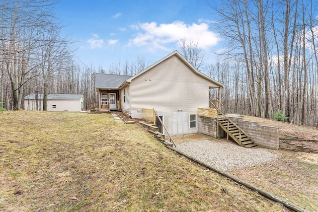 view of side of property with a wooden deck, a yard, and a shingled roof